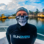 A diver wears a skeleton buff on a halloween event dive in roatan.