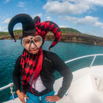 A diver dressed as a court jester on a halloween event dive in roatan.