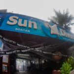 The front of Sun Divers Roatan decorated with "do not enter" tape for halloween