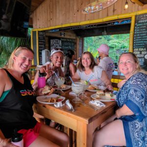 Four women are eating dinner at a restaurant in Roatan, Honduras.