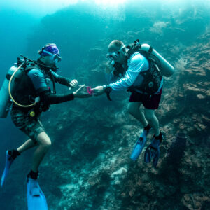 A diver tries to solve a puzzle underwater as part of the Deep Diver Specialty course in Roatan. 