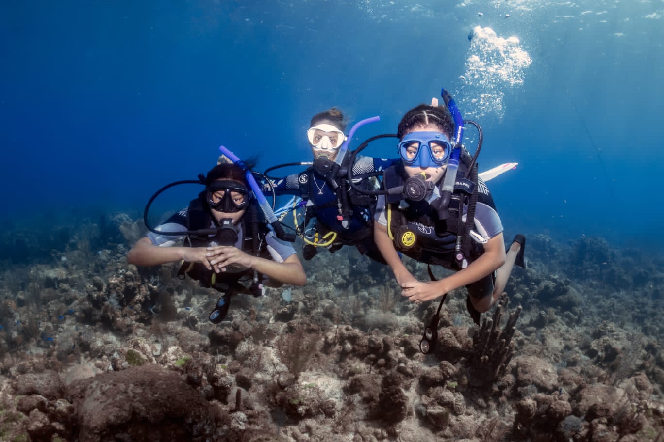 Local girls diving above a reef